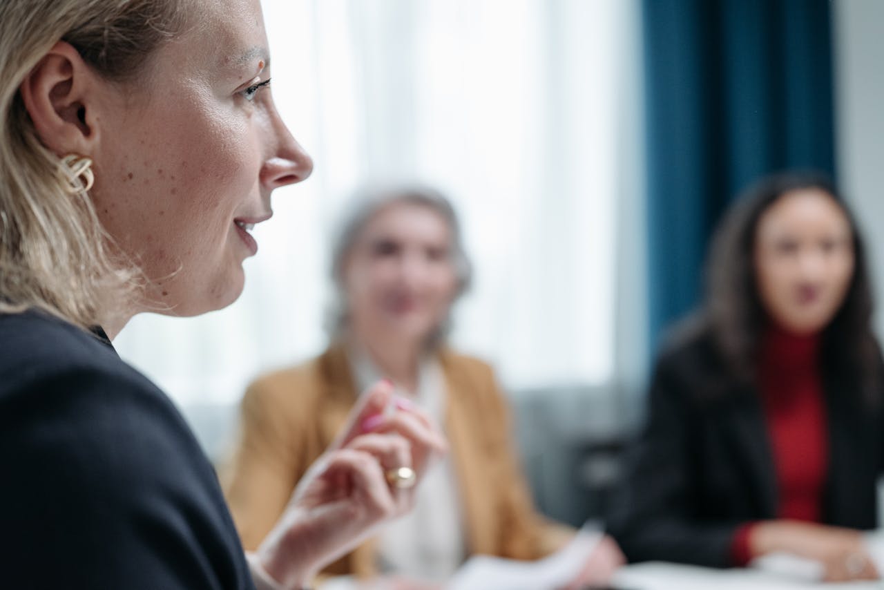 Close-up of women involved in a professional business meeting indoors.